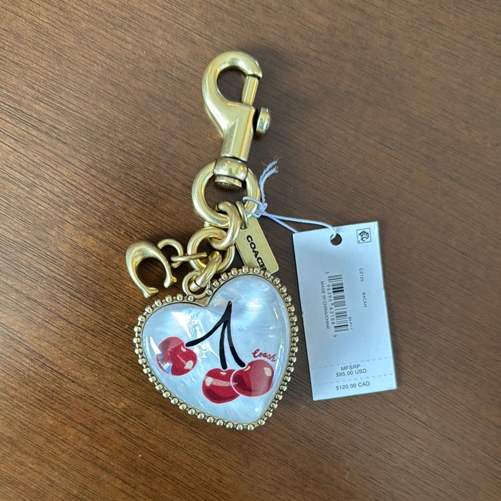 Coach Gold Heart Keychain with Red Cherry Design